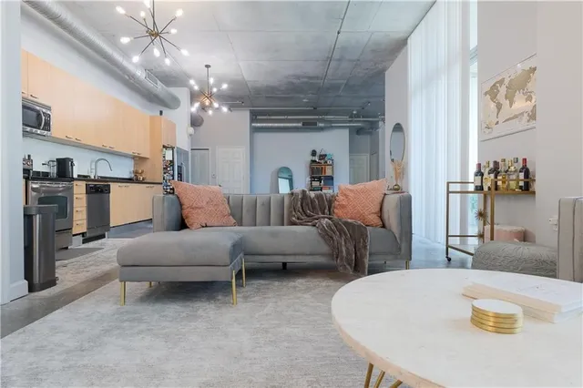a living room with furniture and a chandelier