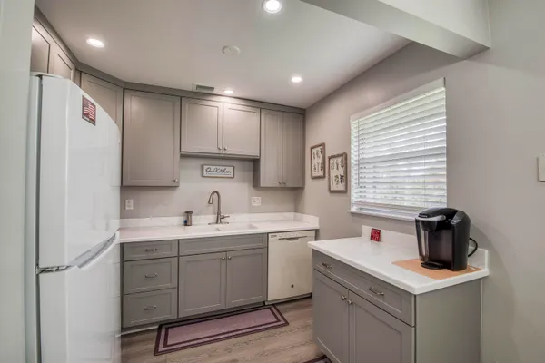 a kitchen with a sink a stove a refrigerator and cabinets