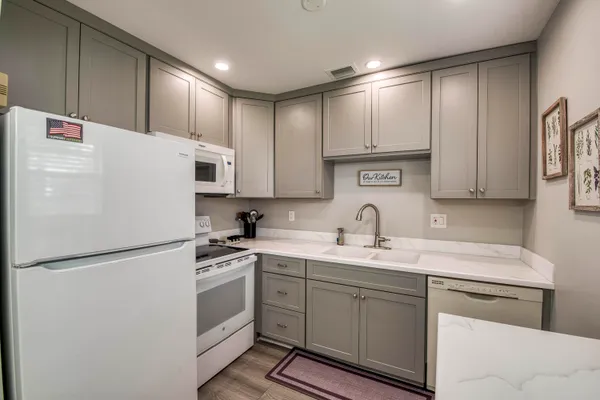 a kitchen with appliances cabinets and a sink