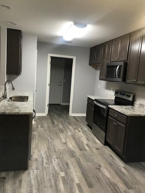 3328 Broadview Circle Crestview, FL 32539 - Photo 18 of 40 a kitchen with stainless steel appliances granite countertop a sink stove and microwave
