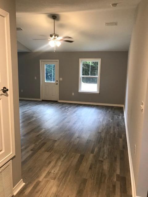 3328 Broadview Circle Crestview, FL 32539 - Photo 5 of 40 an empty room with wooden floor chandelier and windows