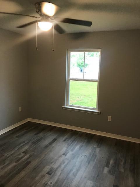 3328 Broadview Circle Crestview, FL 32539 - Photo 7 of 40 a view of an empty room with wooden floor and a window