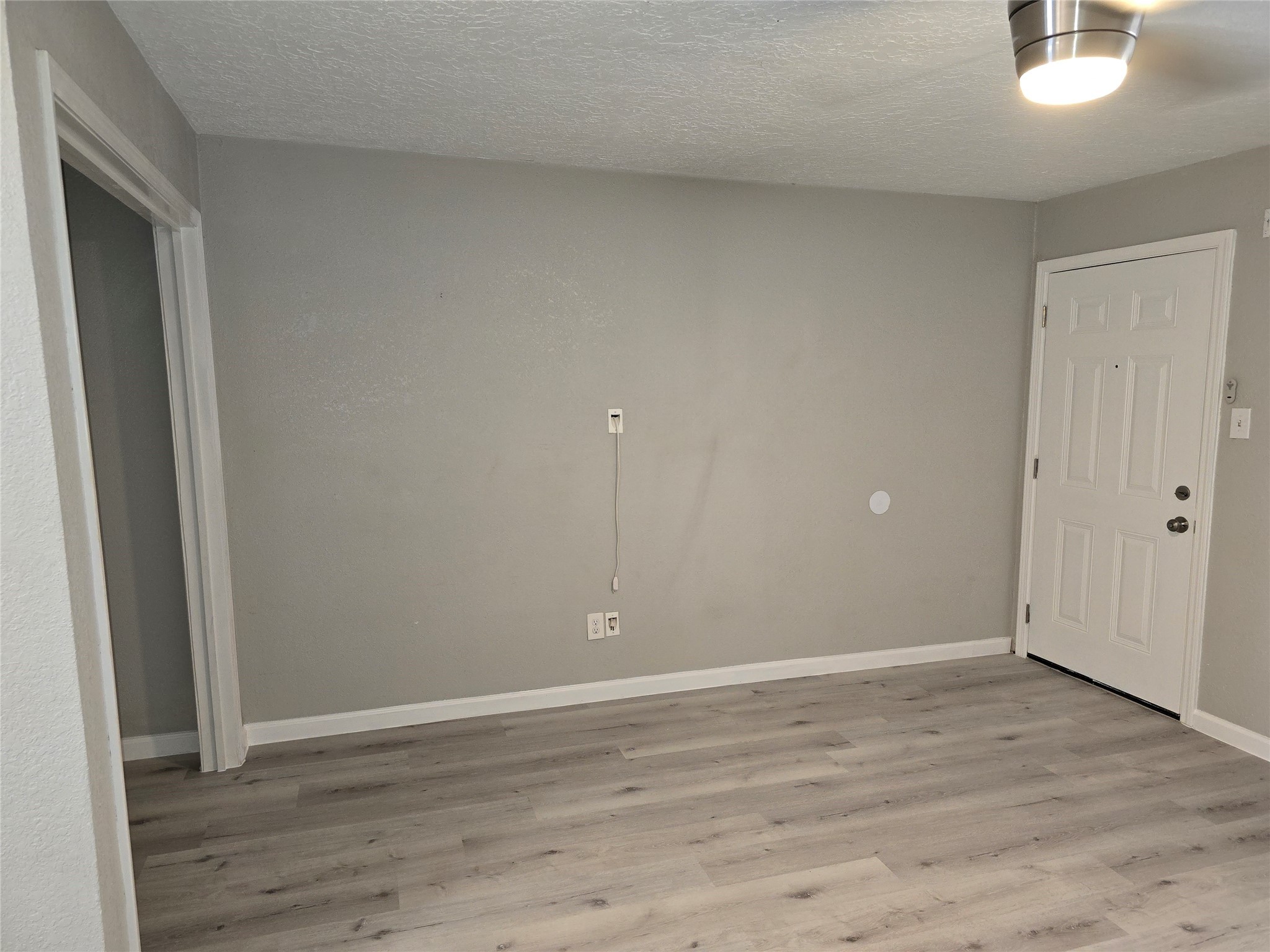 2501 Yoakum Boulevard, Unit 13 Houston, TX 77006 - Photo 13 of 24 a view of an empty room with wooden floor