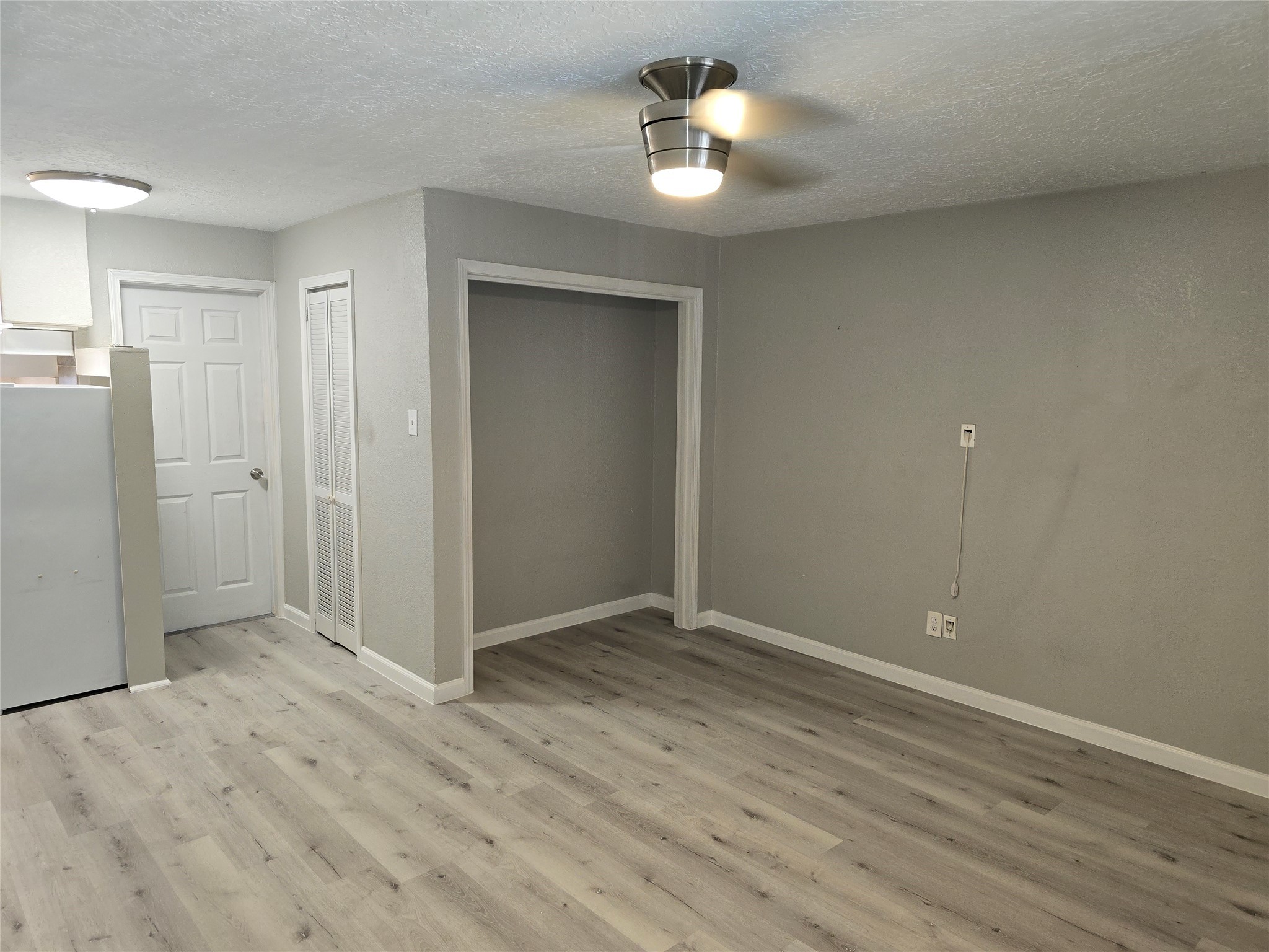 2501 Yoakum Boulevard, Unit 13 Houston, TX 77006 - Photo 17 of 24 wooden floor in an empty room with a window