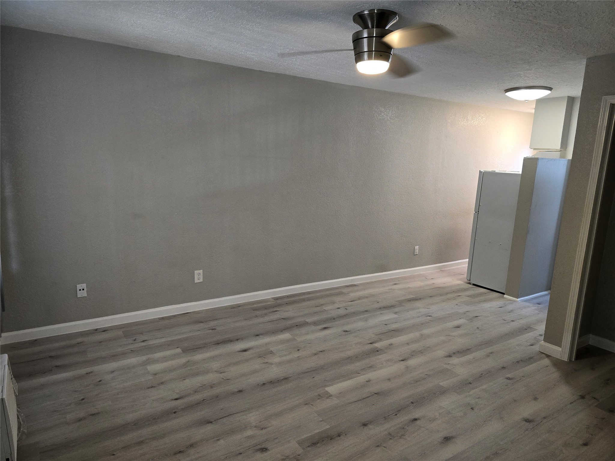 2501 Yoakum Boulevard, Unit 13 Houston, TX 77006 - Photo 9 of 24 wooden floor in an empty room with a window