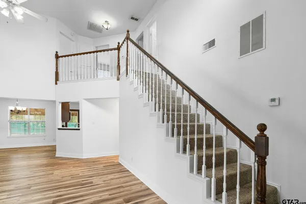 a view of entryway and hall with wooden floor