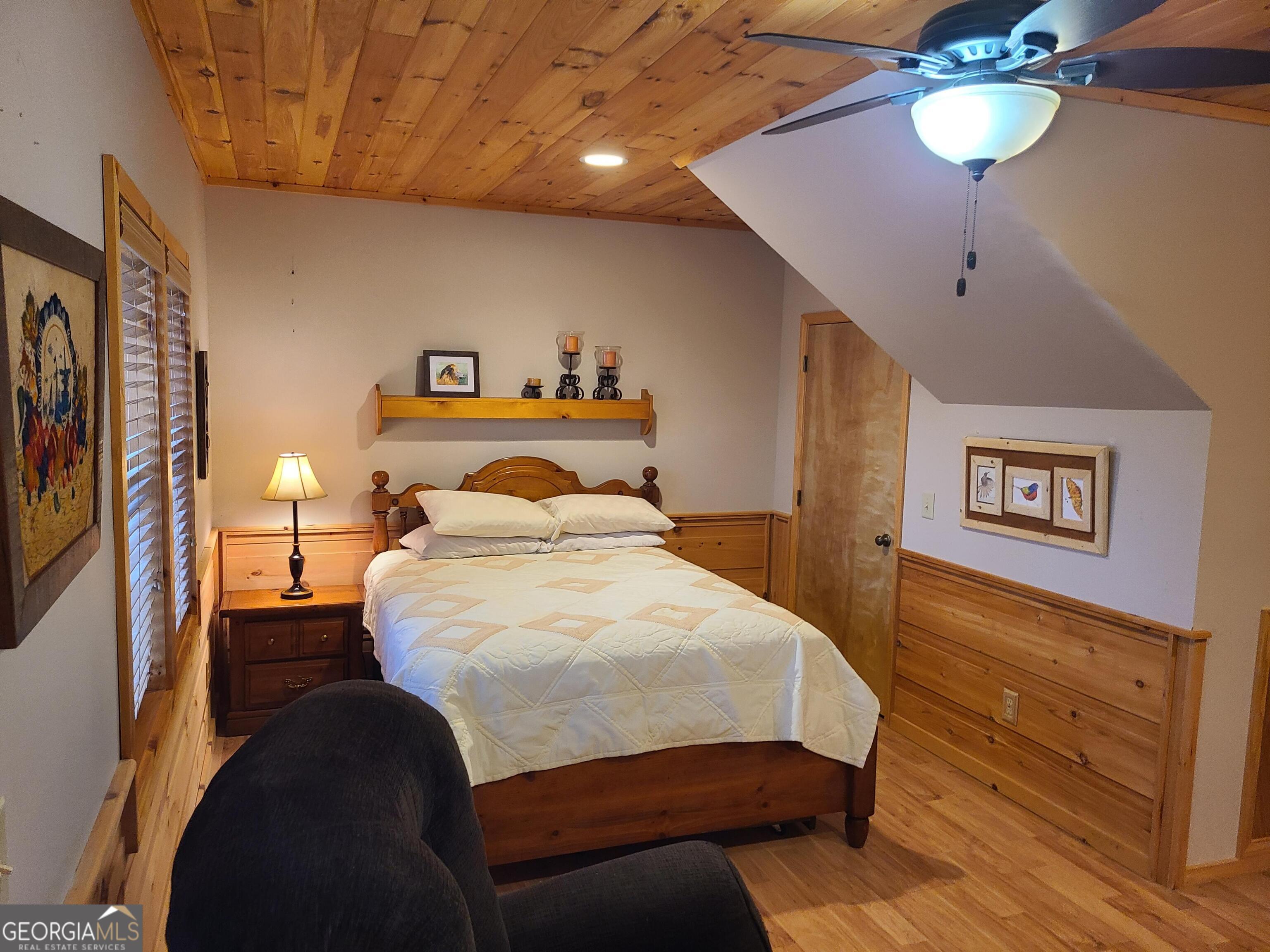 191 Deer Run Road Blairsville, GA 30512 - Photo 11 of 24 a bedroom with a bed and a chandelier