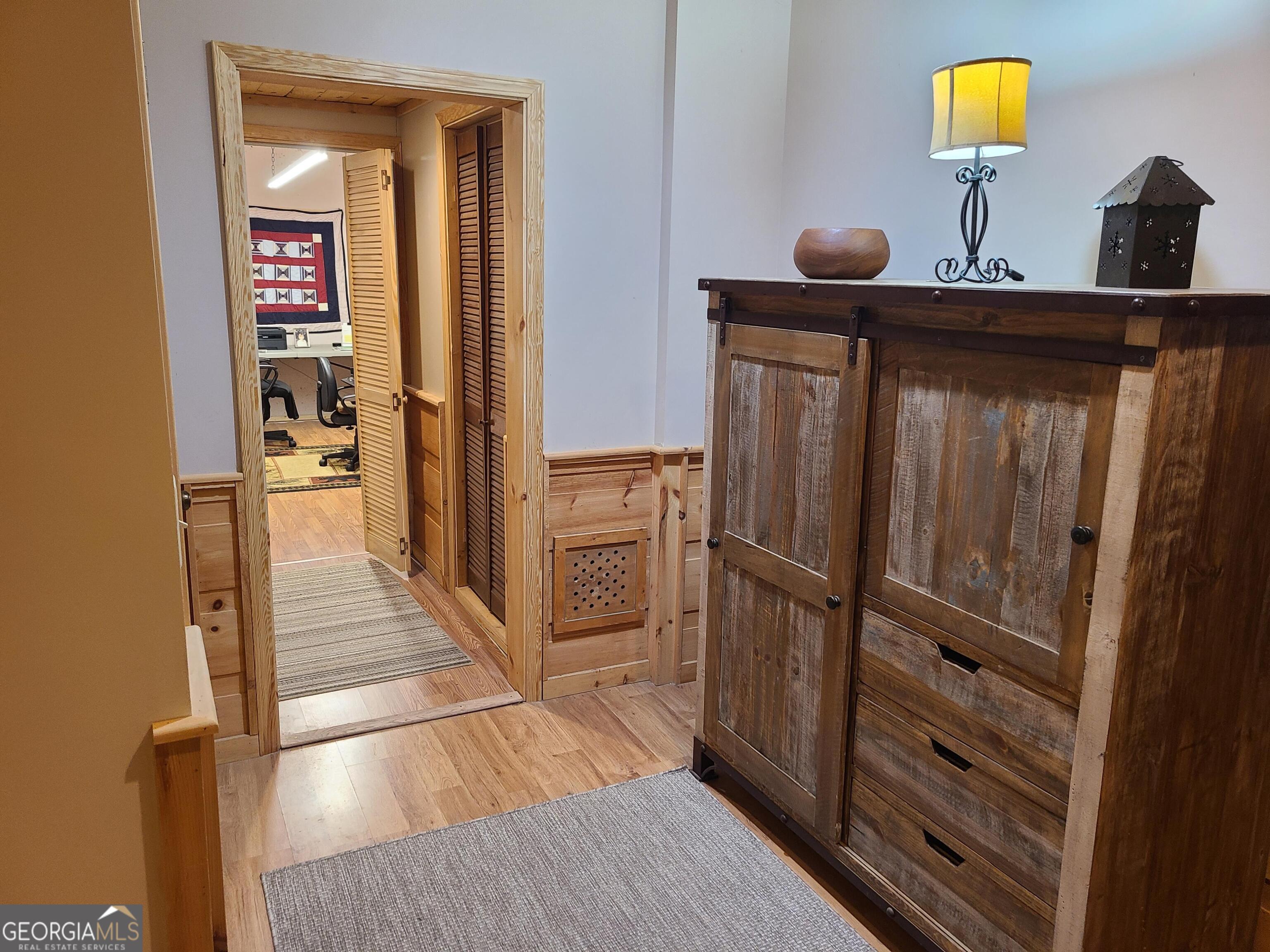 191 Deer Run Road Blairsville, GA 30512 - Photo 13 of 24 a hallway with cabinets and a wooden floor
