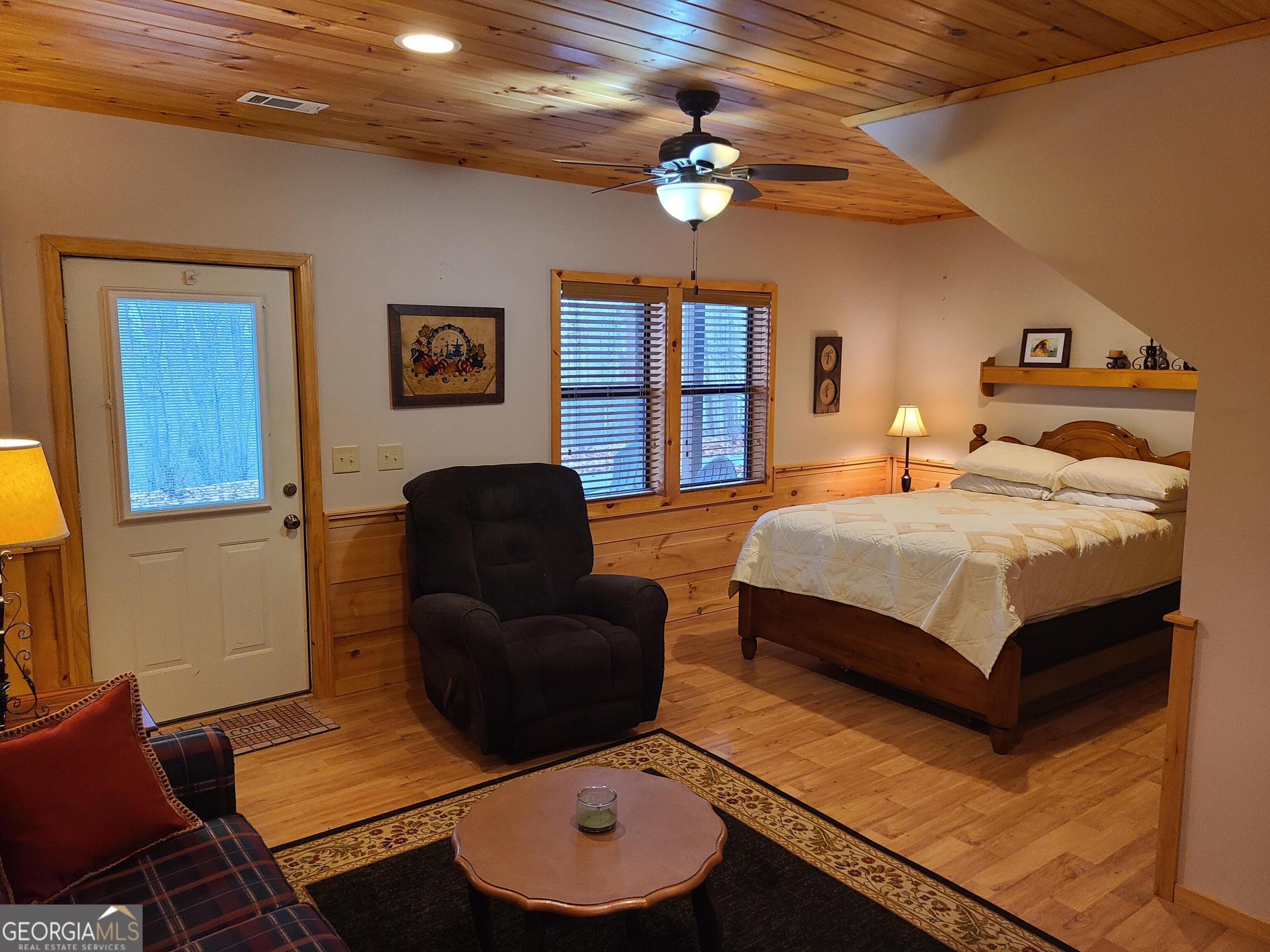 191 Deer Run Road Blairsville, GA 30512 - Photo 14 of 24 a bedroom with a bed couch and window