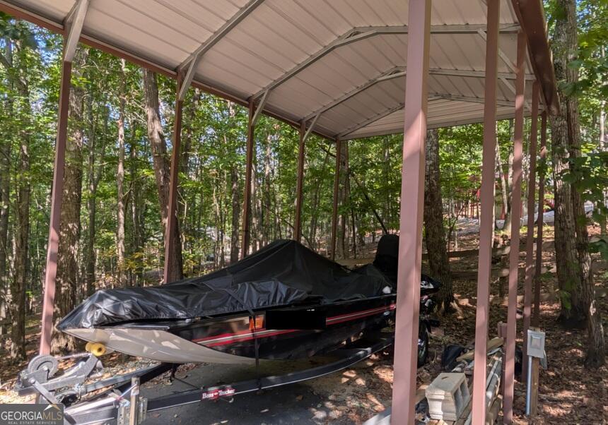 191 Deer Run Road Blairsville, GA 30512 - Photo 22 of 24 a backyard of a house with table and chairs under an umbrella