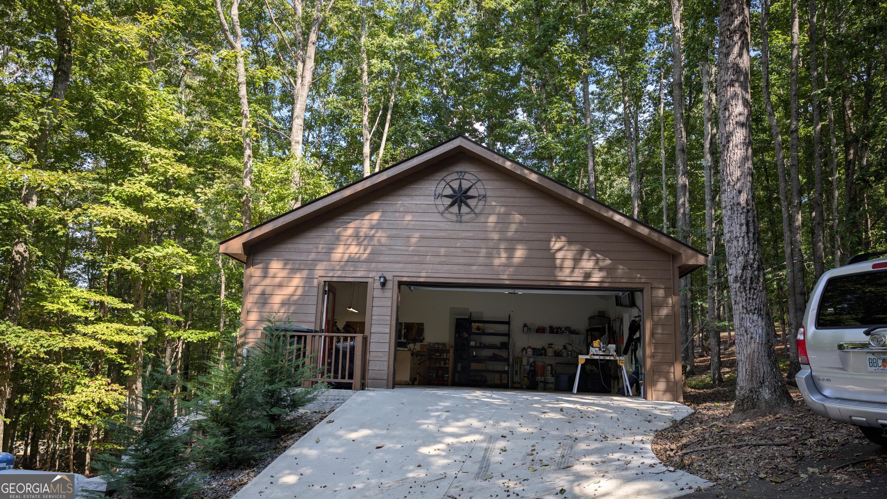 191 Deer Run Road Blairsville, GA 30512 - Photo 23 of 24 a view of a house with potted plants and large trees