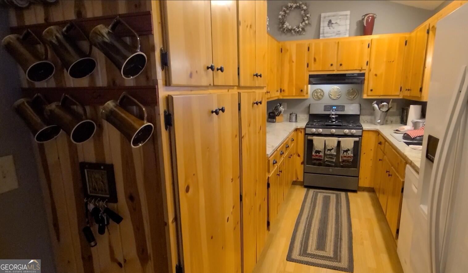 191 Deer Run Road Blairsville, GA 30512 - Photo 8 of 24 a view of a refrigerator with wooden floor