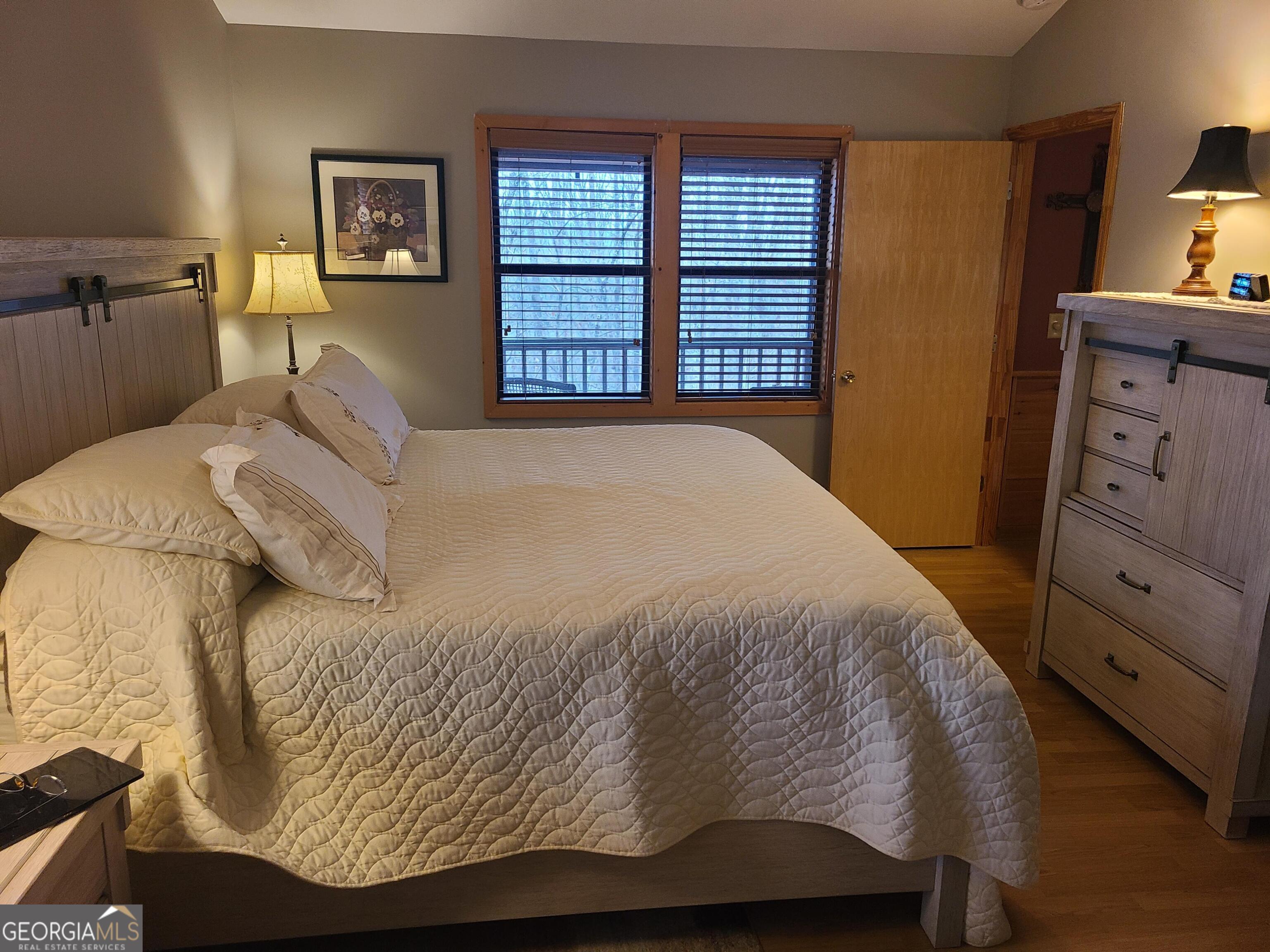 191 Deer Run Road Blairsville, GA 30512 - Photo 10 of 24 a bedroom with a bed and window