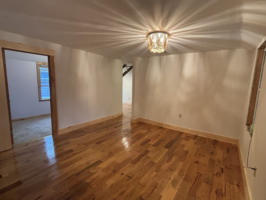 36 Washington Street Greenfield, MA 01301 - Photo 2 of 14 a view of empty room with wooden floor and fan
