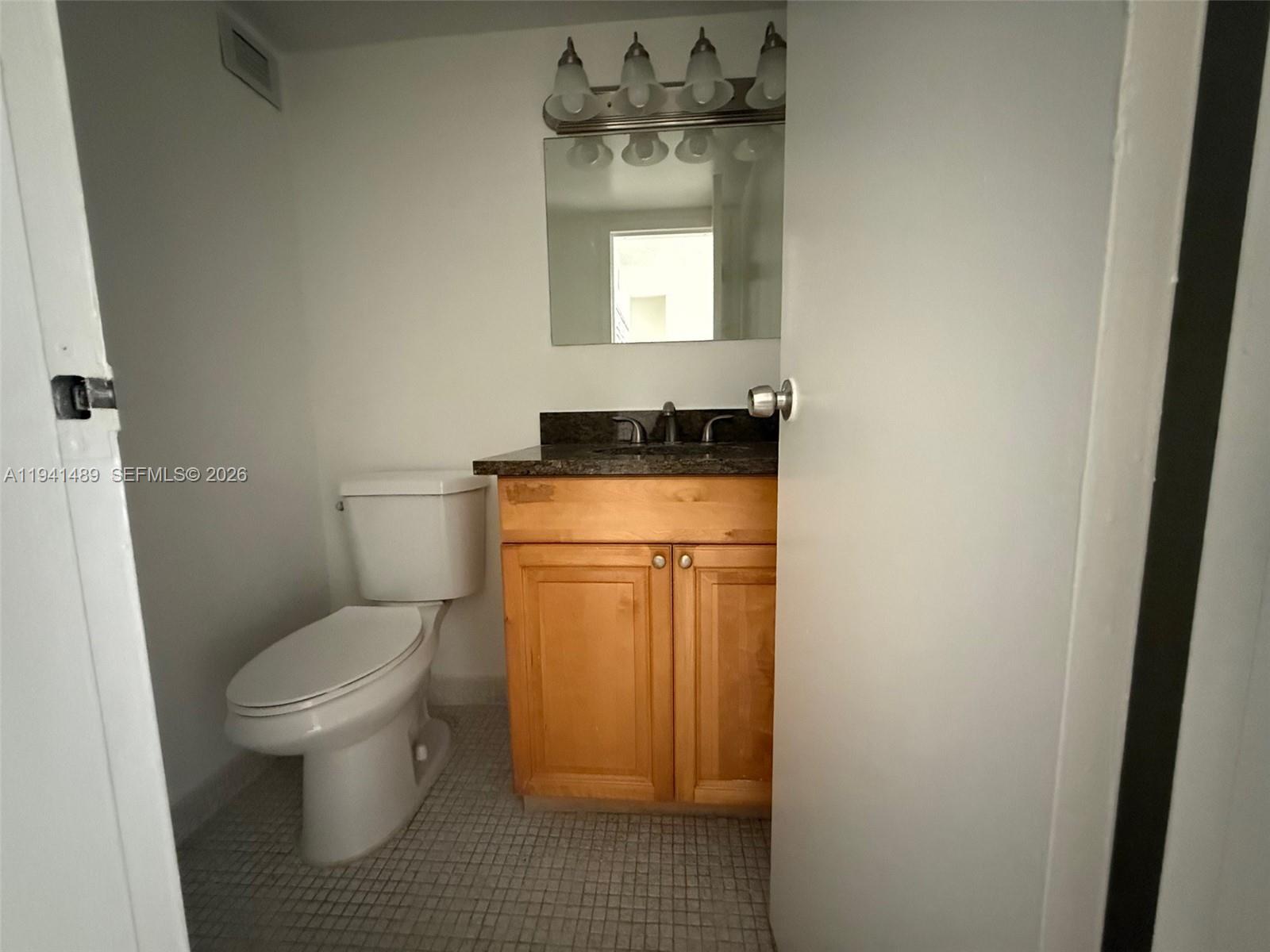 16919 North Bay Road, Unit 314 Sunny Isles Beach, FL 33160 - Photo 25 of 34 a bathroom with a toilet sink and mirror