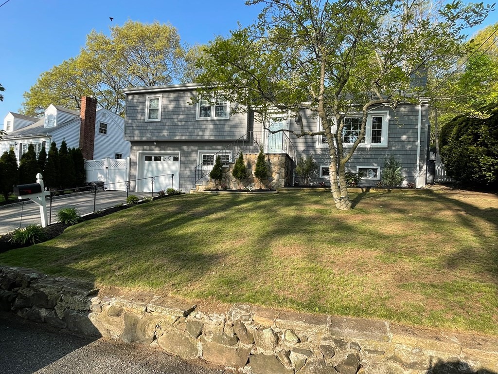 a view of a house with backyard and sitting area