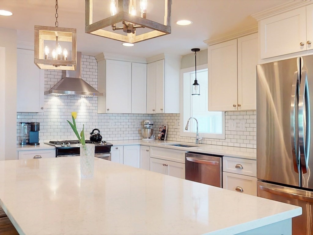 30 Baker Road Arlington, MA 02474 - Photo 14 of 42 a kitchen with stainless steel appliances a refrigerator sink and cabinets