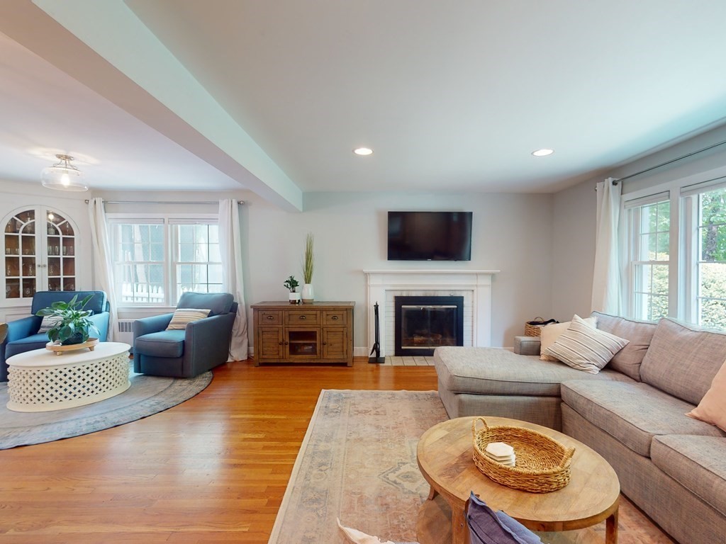 30 Baker Road Arlington, MA 02474 - Photo 5 of 42 a living room with furniture a fireplace and a flat screen tv