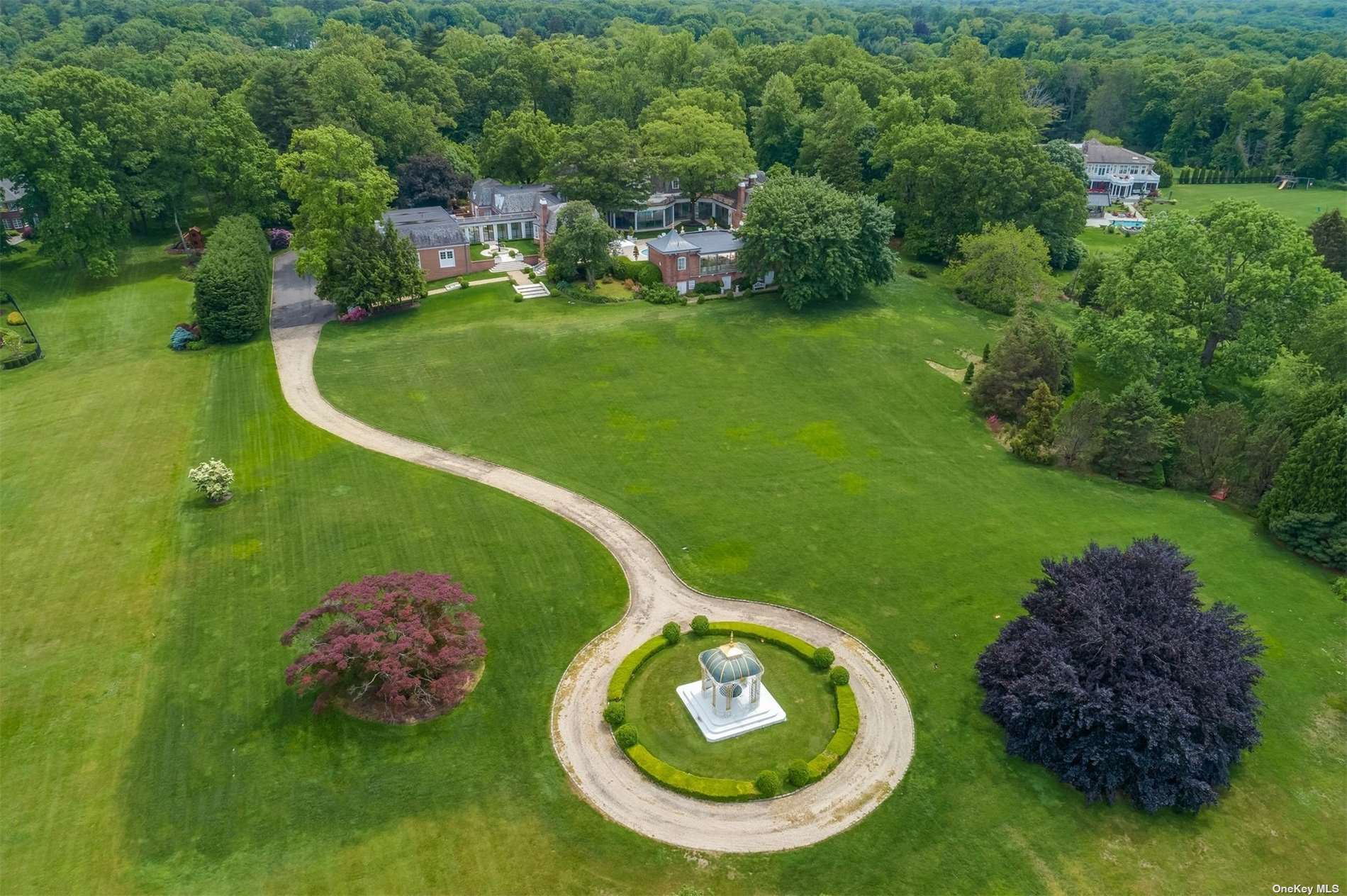La Colline Drive Mill Neck, NY 11765 - Photo 1 of 1 a backyard with table and chairs and a fountain