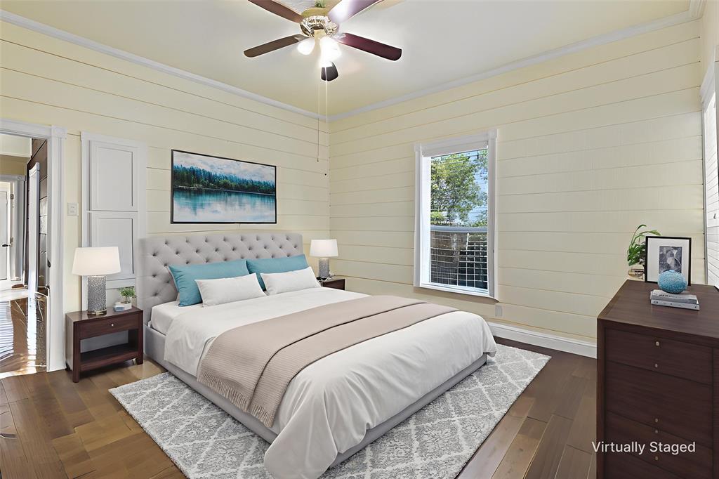 5824 Boone Street Sachse, TX 75048 - Photo 14 of 37 a bedroom with a bed and a chandelier