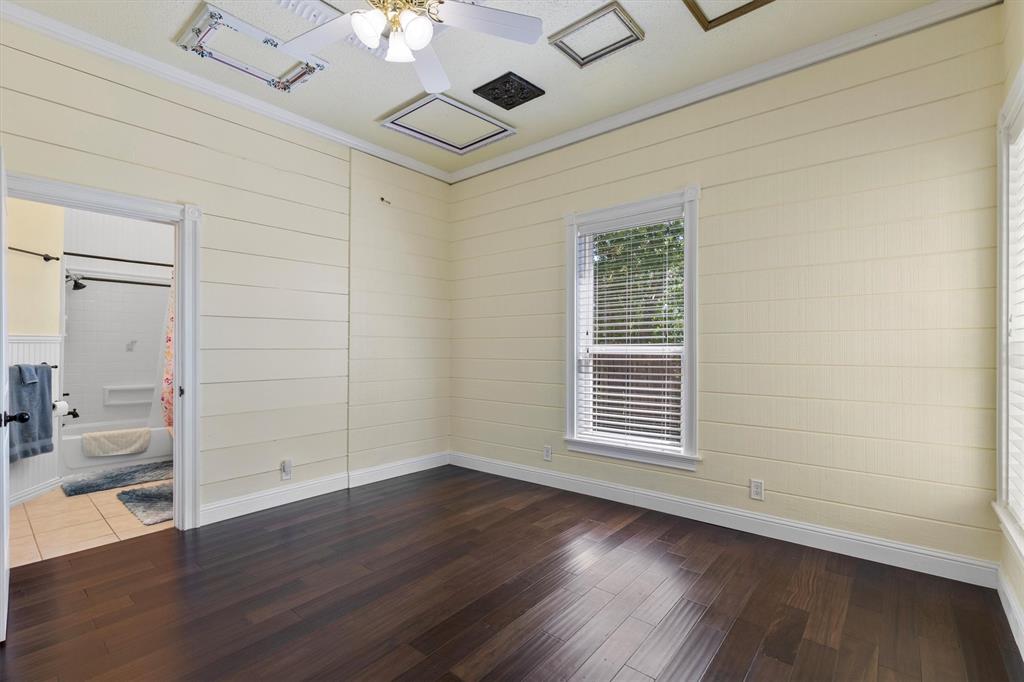 5824 Boone Street Sachse, TX 75048 - Photo 18 of 37 a view of an empty room with wooden floor and a window