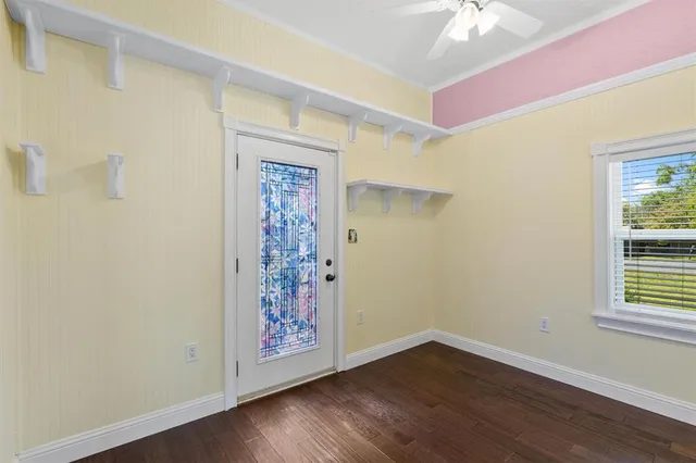 a view of a room with wooden floor and a window