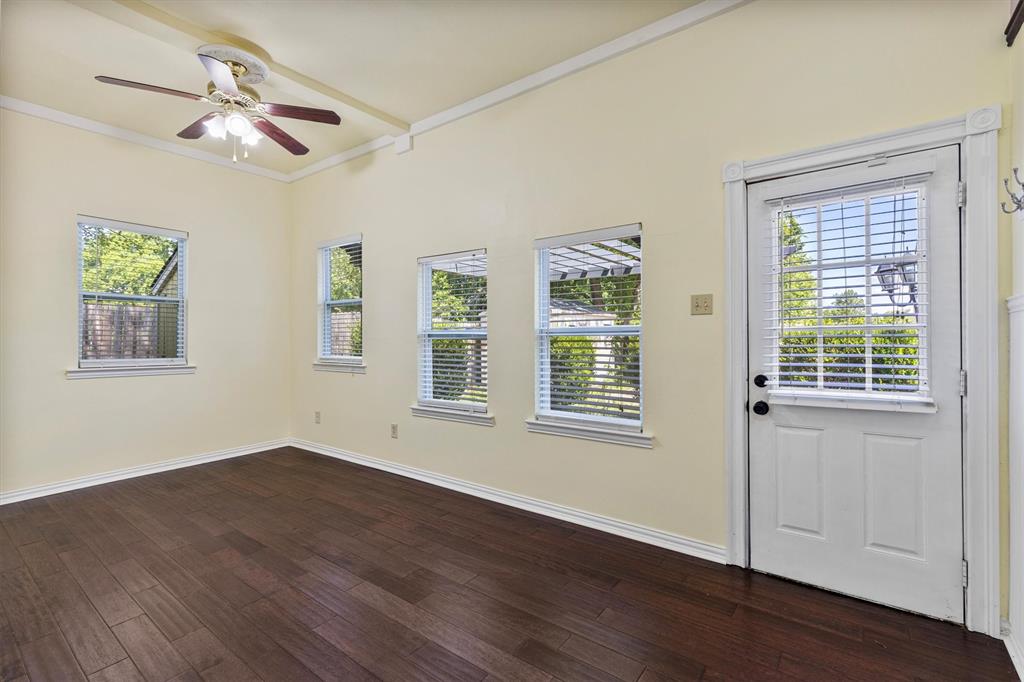 5824 Boone Street Sachse, TX 75048 - Photo 22 of 37 a view of an empty room with wooden floor and a window