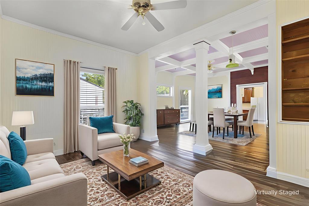 5824 Boone Street Sachse, TX 75048 - Photo 3 of 37 a living room with furniture a wooden floor and a chandelier