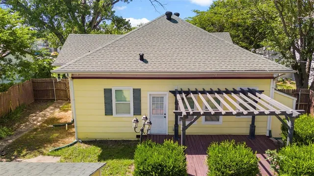 an aerial view of residential house with outdoor space and trees all around