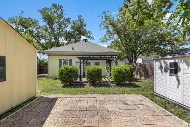 an aerial view of residential houses with outdoor space and a lake view