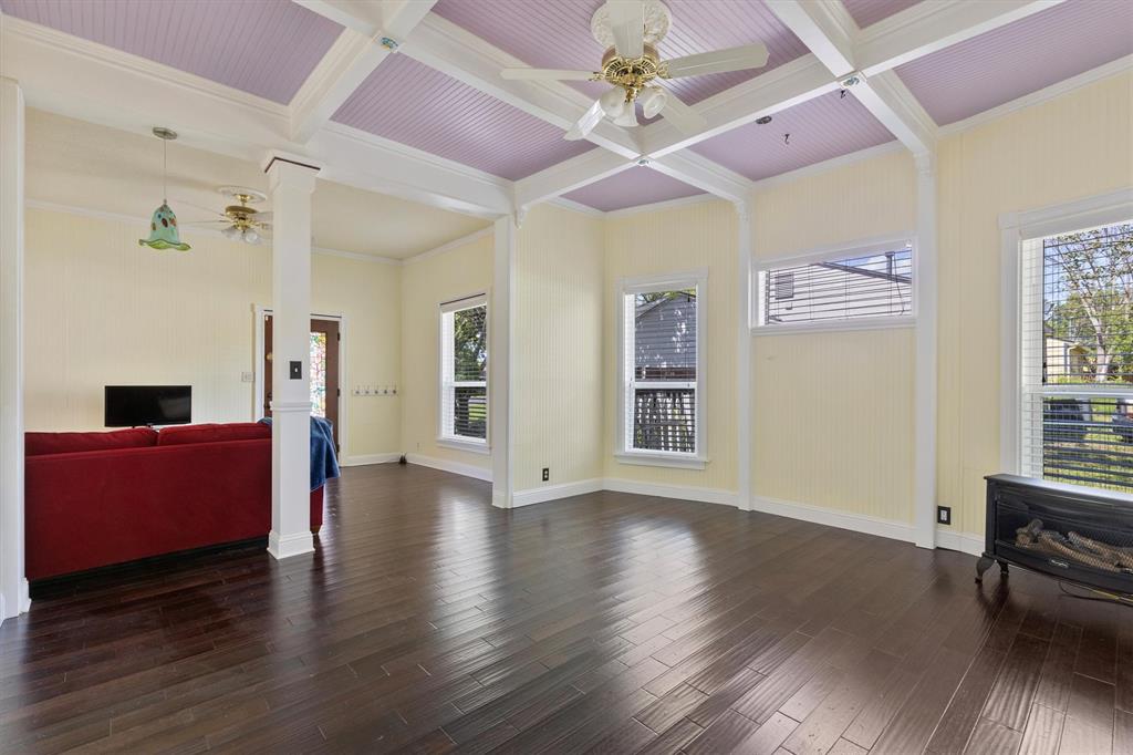 5824 Boone Street Sachse, TX 75048 - Photo 8 of 37 a view of an empty room with wooden floor and a window