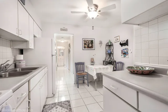a view of a kitchen with furniture and cars