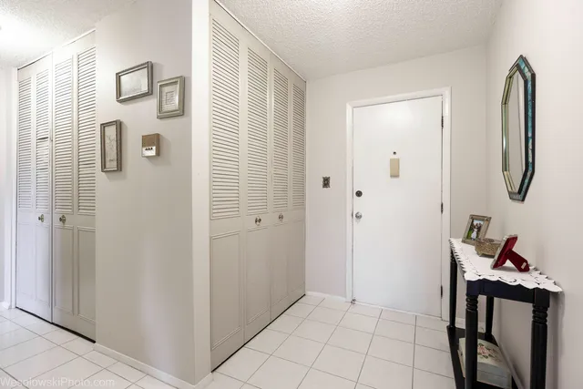 a very nice looking room with white cabinets and wooden floor