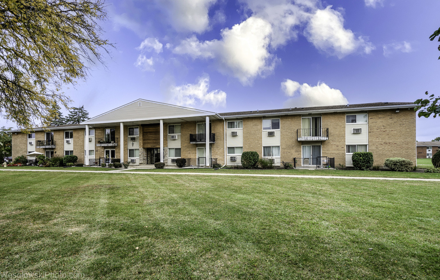 9209 Potter Road, Unit 2F Des Plaines, IL 60016 - Photo 2 of 25 a front view of a house with a garden