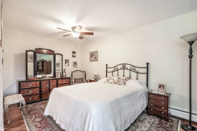 a large bedroom with bed and a chandelier