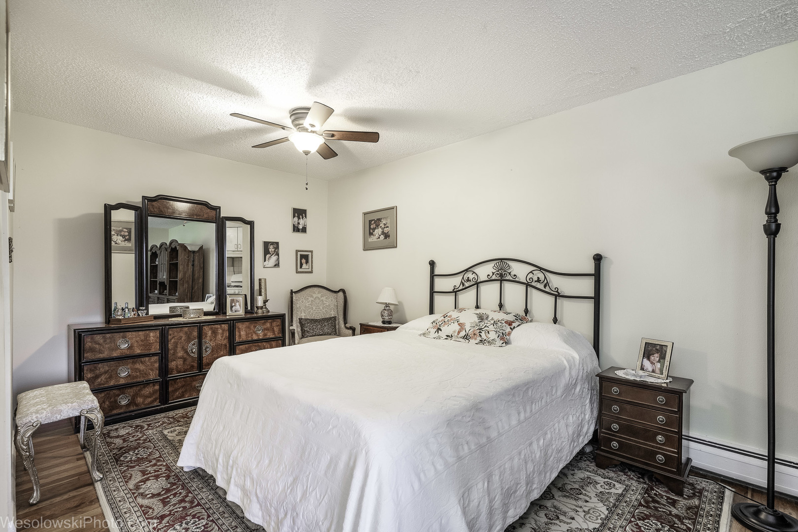 9209 Potter Road, Unit 2F Des Plaines, IL 60016 - Photo 9 of 25 a large bedroom with bed and a chandelier