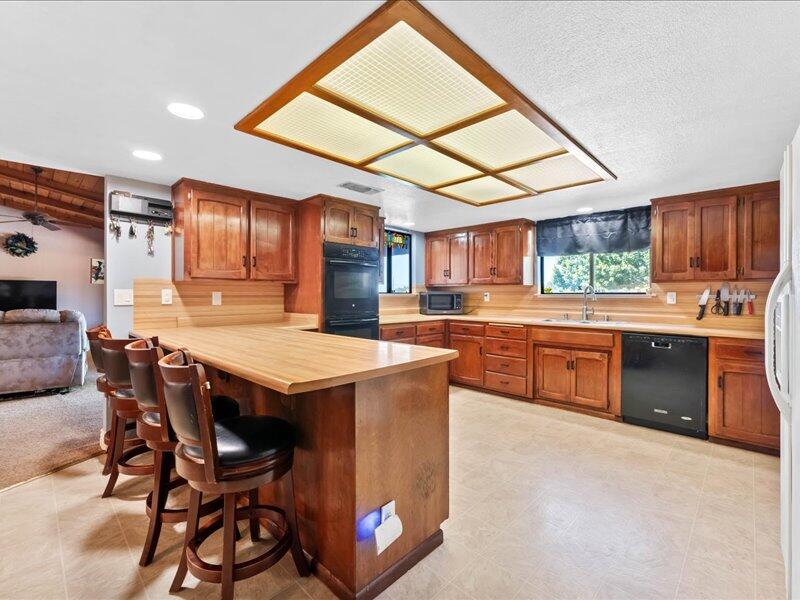 19907 Hidden Hills Road Cottonwood, CA 96022 - Photo 4 of 20 a kitchen with a stove a table and chairs in it
