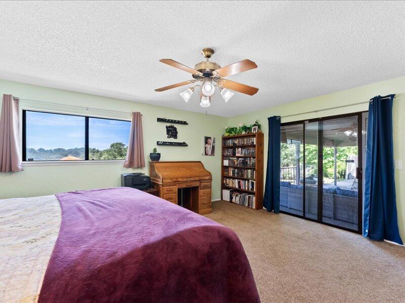 19907 Hidden Hills Road Cottonwood, CA 96022 - Photo 6 of 20 a bed room with a bed and a television