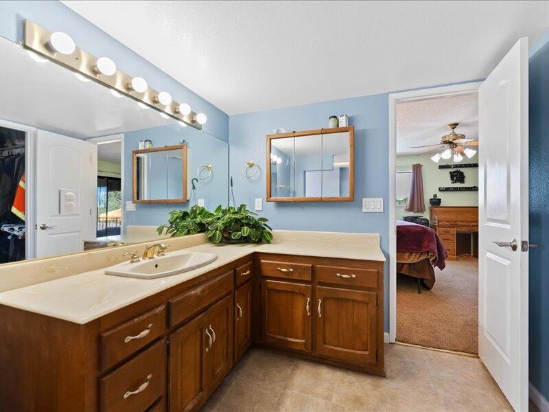 19907 Hidden Hills Road Cottonwood, CA 96022 - Photo 7 of 20 a spacious bathroom with a sink and a mirror