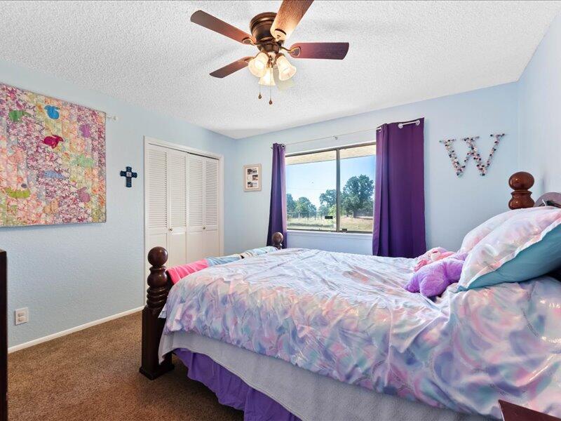 19907 Hidden Hills Road Cottonwood, CA 96022 - Photo 9 of 20 a bedroom with a bed and a painting on the wall