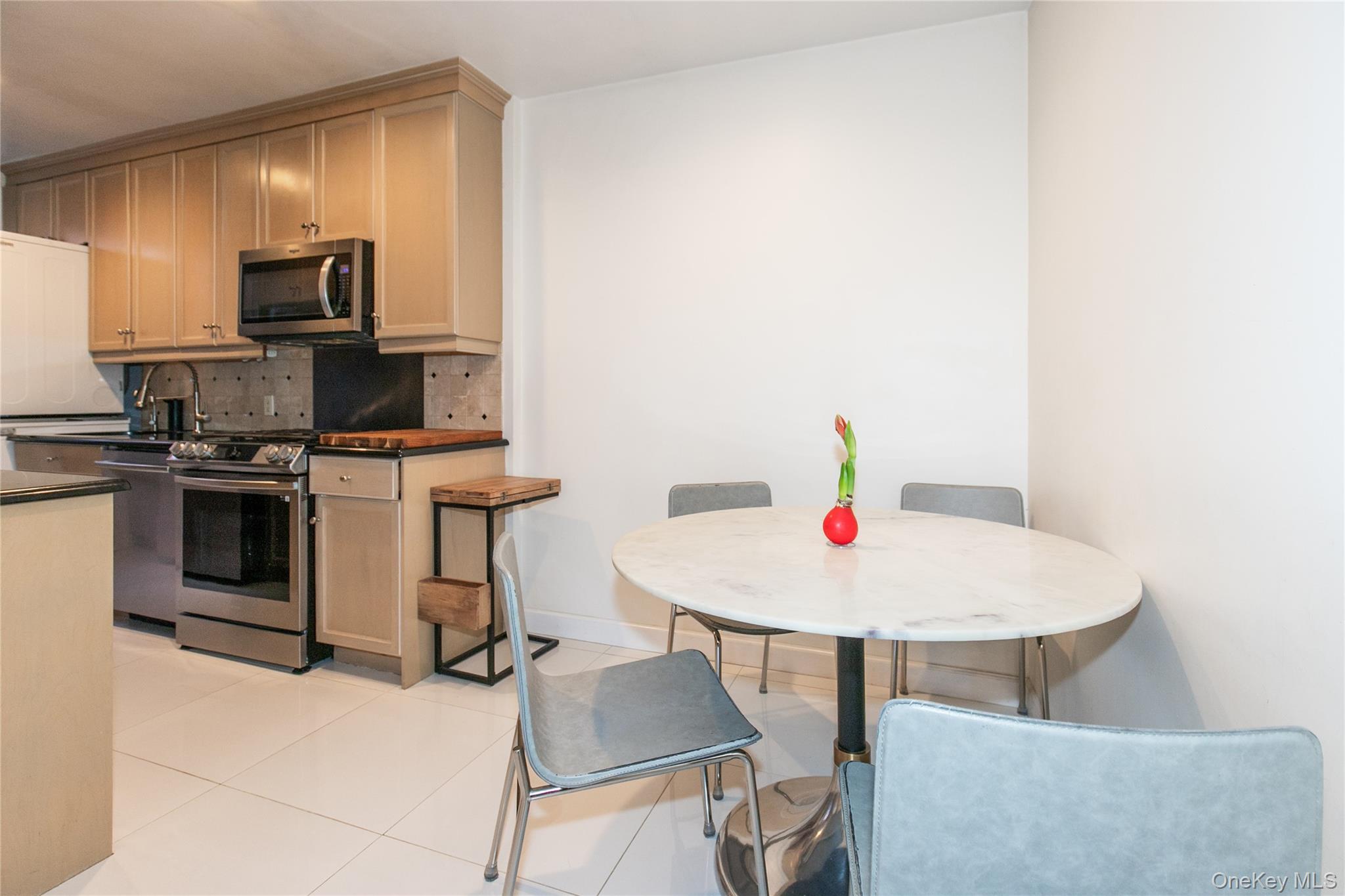 90 Schenck Avenue, Unit 3P Great Neck, NY 11021 - Photo 11 of 24 a living room with dining table and stainless steel appliances