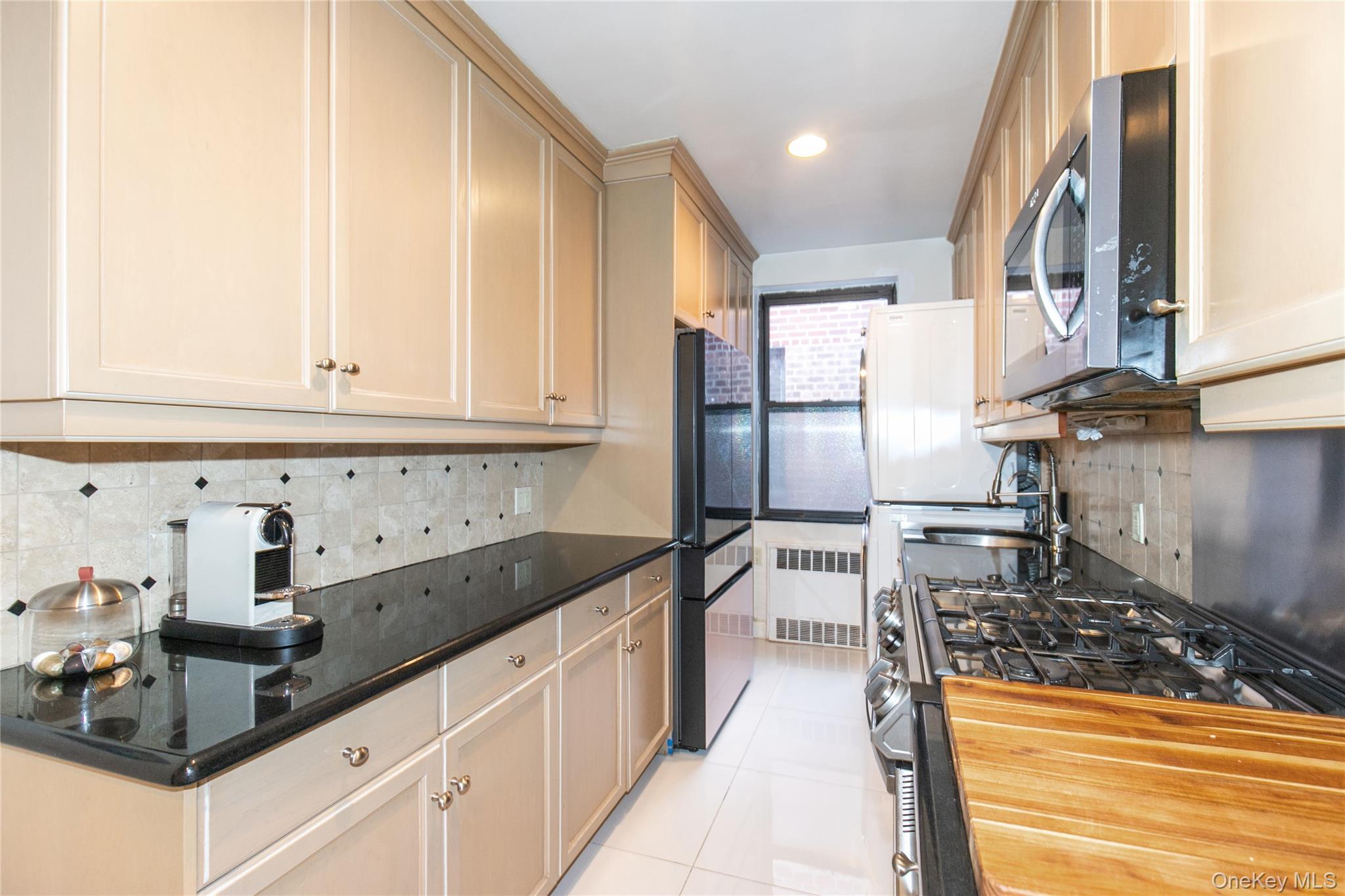 90 Schenck Avenue, Unit 3P Great Neck, NY 11021 - Photo 13 of 24 a kitchen with granite countertop a sink a stove and refrigerator