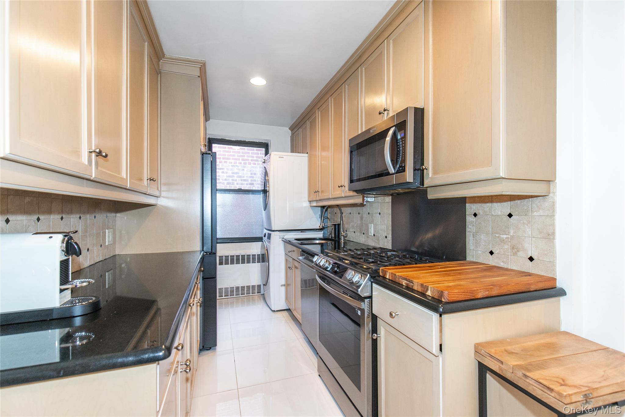 90 Schenck Avenue, Unit 3P Great Neck, NY 11021 - Photo 14 of 24 a kitchen with stainless steel appliances granite countertop a sink stove and refrigerator