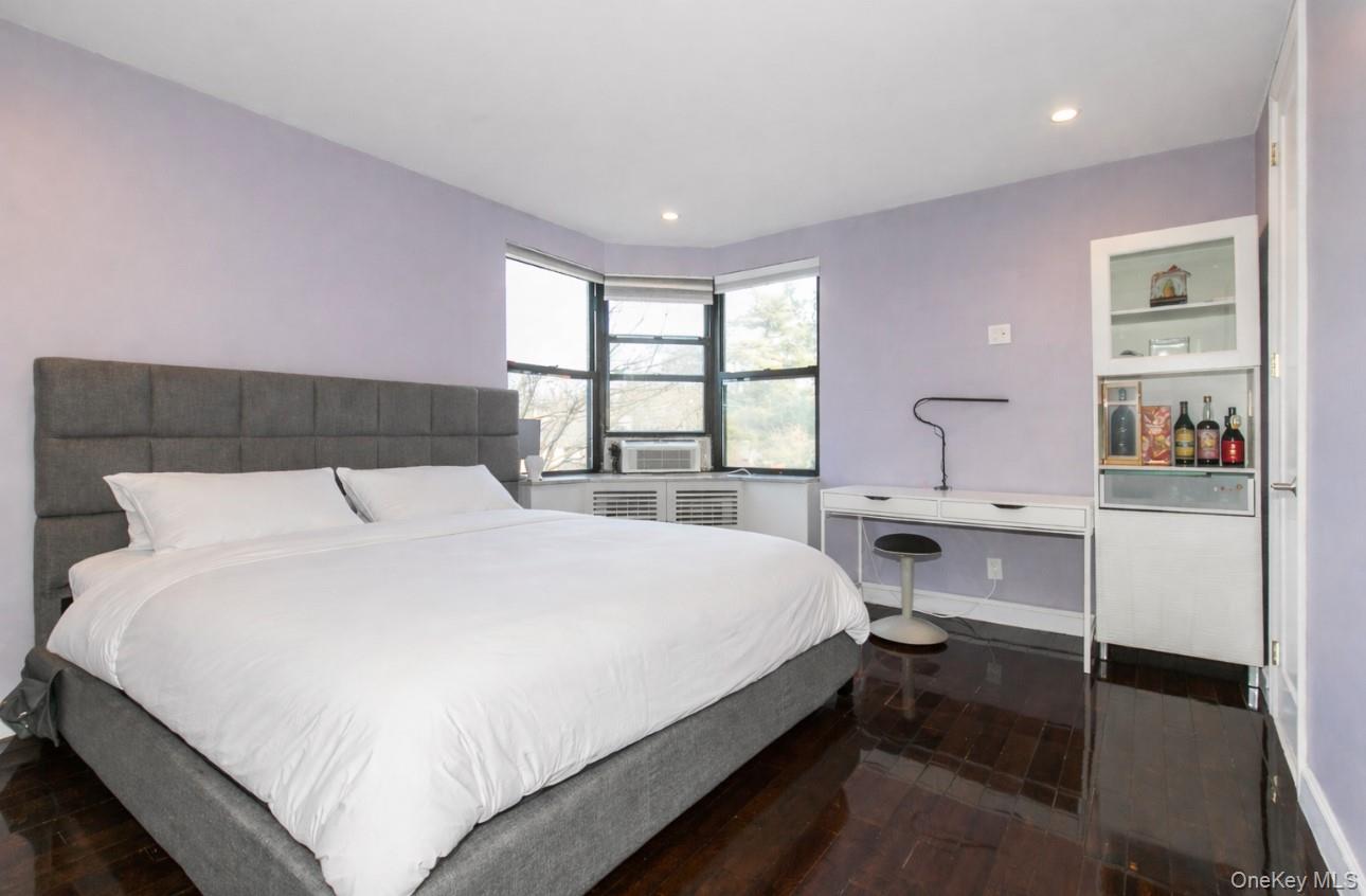 90 Schenck Avenue, Unit 3P Great Neck, NY 11021 - Photo 16 of 24 a large bed sitting in a bedroom next to a window