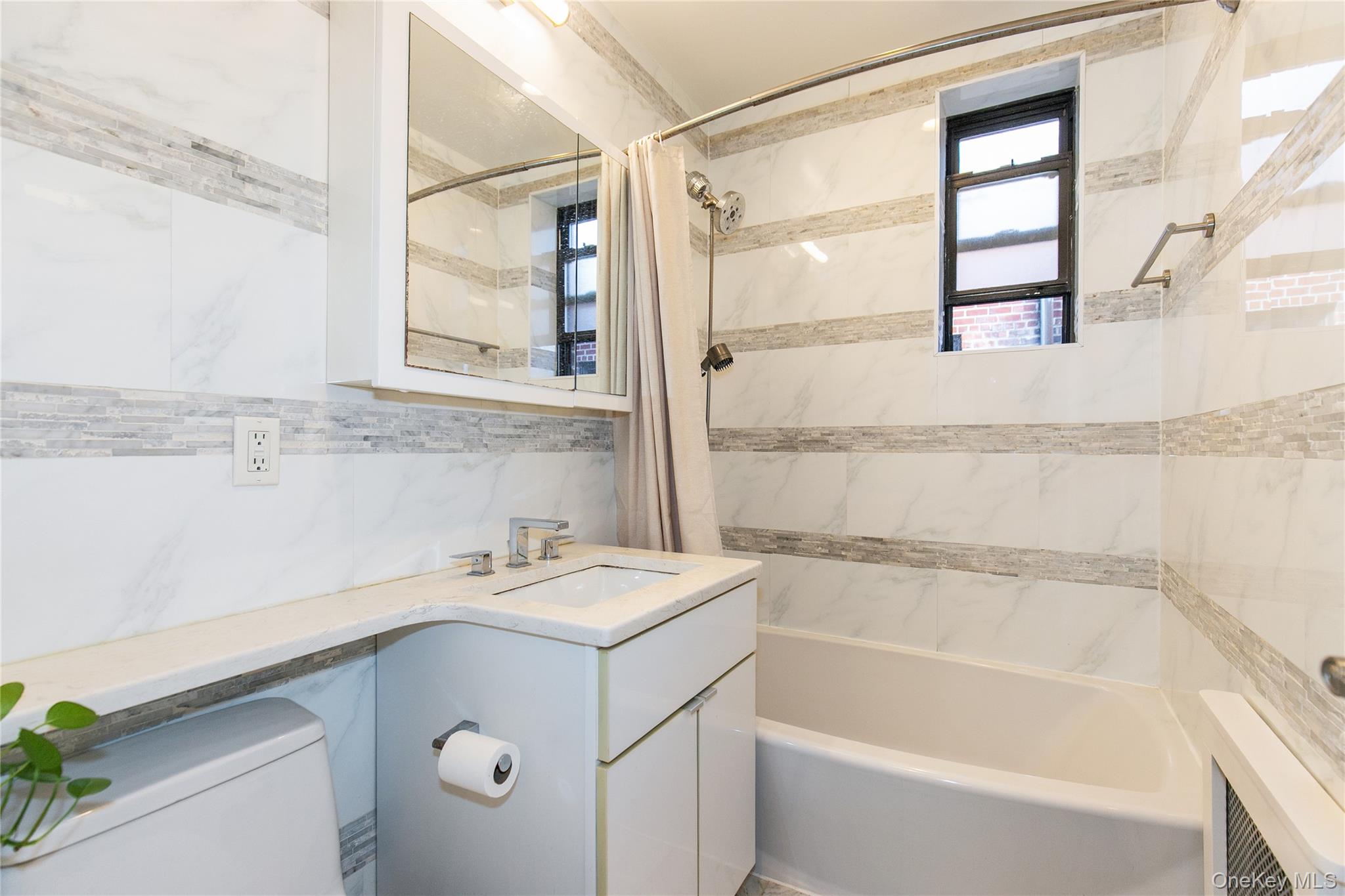 90 Schenck Avenue, Unit 3P Great Neck, NY 11021 - Photo 19 of 24 a bathroom with a sink and a bathtub