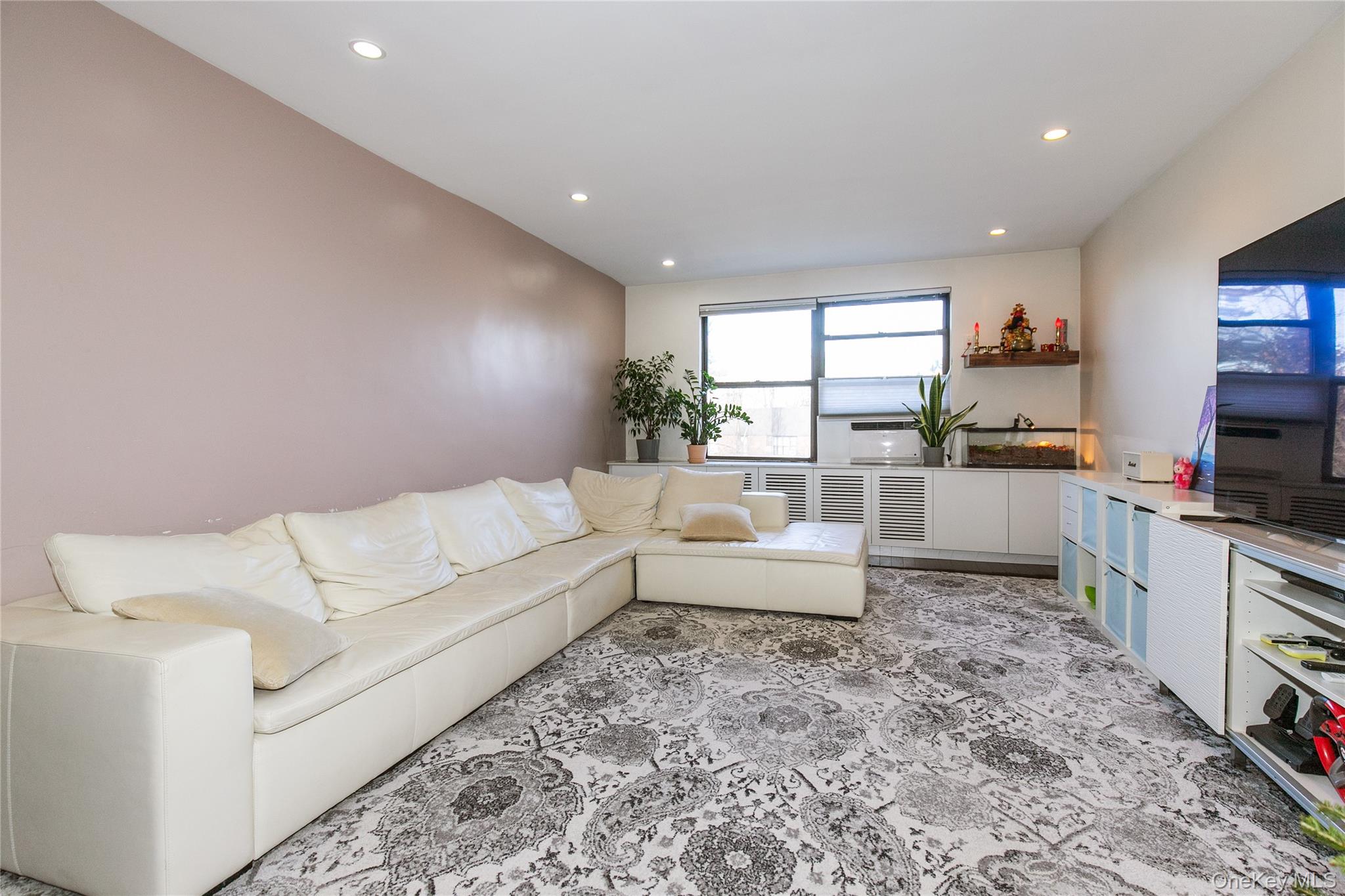 90 Schenck Avenue, Unit 3P Great Neck, NY 11021 - Photo 7 of 24 a living room with furniture and a flat screen tv