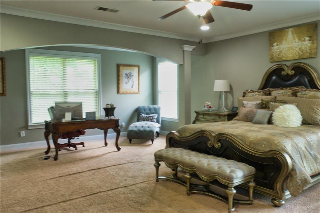 5639 Sunbury Loop Evans, GA 30809 - Photo 12 of 22 a bedroom with a bed and a chandelier