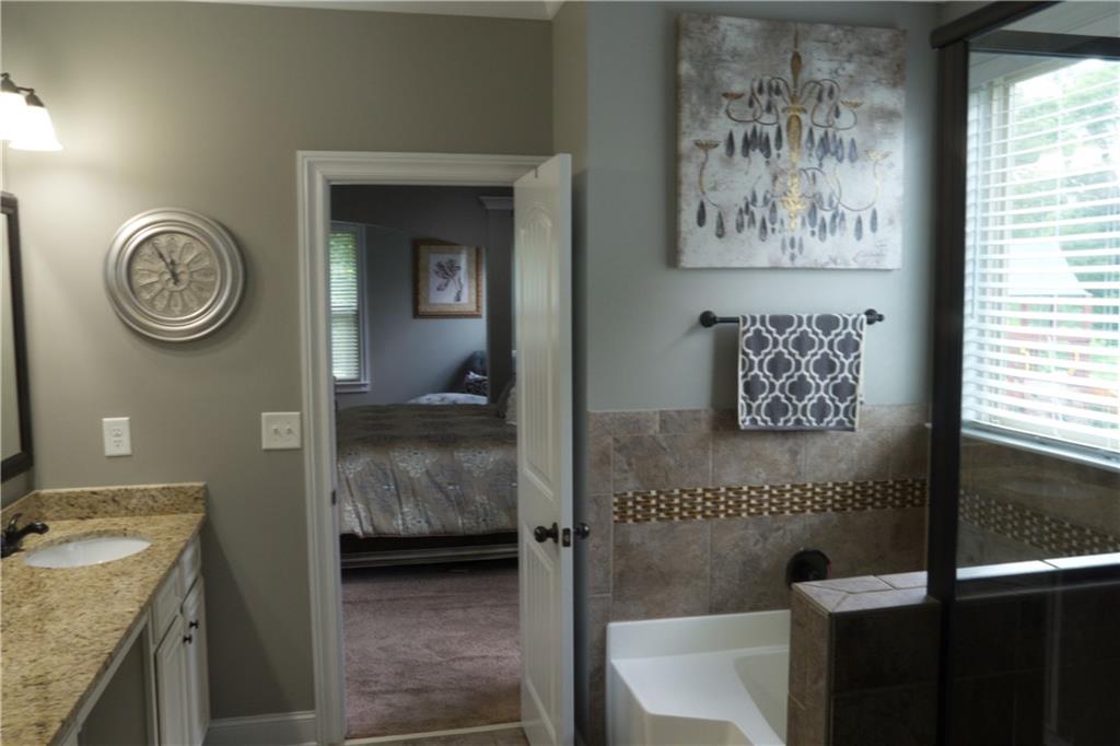 5639 Sunbury Loop Evans, GA 30809 - Photo 14 of 22 a bathroom with a granite countertop sink and a washing machine