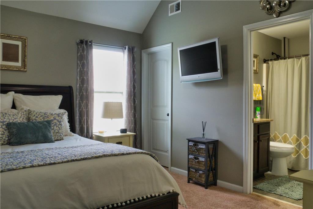 5639 Sunbury Loop Evans, GA 30809 - Photo 16 of 22 a bedroom with a bed and a flat tv screen on dresser