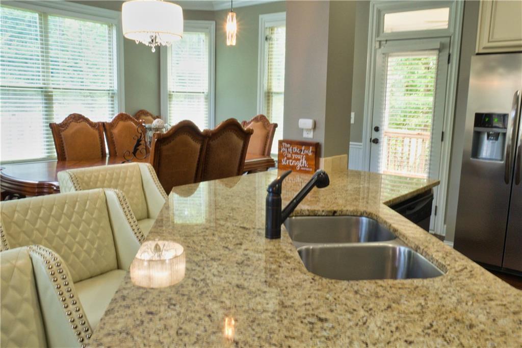 5639 Sunbury Loop Evans, GA 30809 - Photo 8 of 22 a kitchen with stainless steel appliances kitchen island granite countertop a sink and a granite counter tops